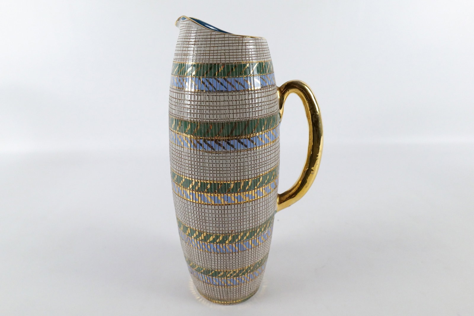 Mid Century Modern Bitossi Italy Aldo Londi Pitcher: Mid Century Modern Bitossi Italy Aldo Londi Pitcher. Good Condition with minor loss to gold paint on handle. Measures 12" tall x 7" wide. All invoices must be paid within 24 hours of the sale. We offe