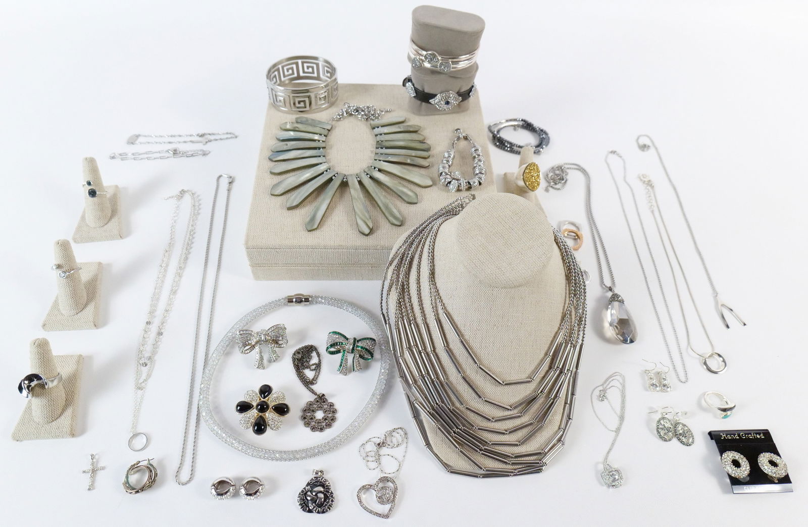 Large Group of Silver Tone Costume Jewelry: Large Group of Silver Tone Costume Jewelry. The lot includes a mix of modern silver tone costume jewelry. Featuring a sz 8 silver tone ring set with a 28.3mm x 18.3mm gold plated druzy quartz by Chris