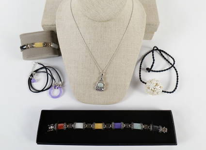 Group of Sterling and Jade Jewelry and More: Group of Sterling and Jade Jewelry and More. The lot includes a mix of jade and sterling jewelry and more. Featuring a 23'' long adjustable black satin cord necklace with sterling findings and a