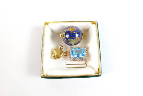 3 Mixed 14K Gold Pendants: 3 Mixed 14K Gold Pendants. The lot includes 3 14K yellow gold pendants. Featuring a 1.30'' x .79'' globe pendant set with an inlaid lapis ocean and continents made of inlaid jade, jasper, mother of pe