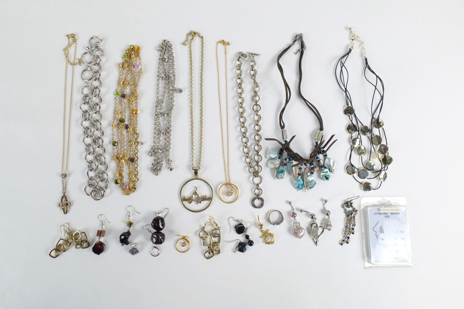 Mixed Gold Tone Costume Jewelry and More: Mixed Gold Tone Costume Jewelry and More. The lot includes a mix of gold and silver tone costume jewelry and body jewelry. Featuring an adjustable 18.5'' long rolo chain with a 2.36'' x 1.77''circular