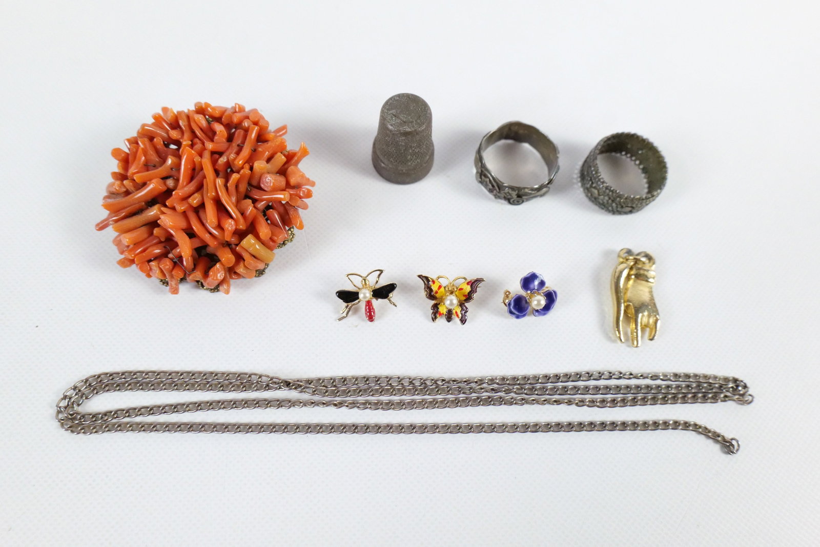 Group of Vintage Brooches and More: Group of Vintage Brooches and More. The lot includes a variety of vintage brooches and more featuring a vintage mid century 1.60'' x 1.60'' circular brooch made of strung natural coral branch fragment