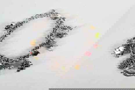 Silver Tone Christmas Charm Bracelet by Brighton: Silver Tone Christmas Charm Bracelet by Brighton. The lot includes an adjustable 9'' long silver tone bracelet by Brighton featuring Christmas themed charms such as a French horn, an articulated ename
