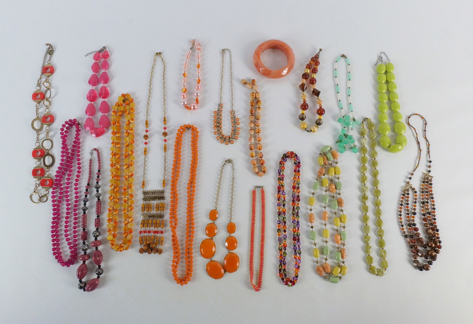 Group of Plastic and Glass Costume Jewelry: Group of Plastic and Glass Costume Jewelry. The lot includes a mix of vintage and modern plastic and glass accented necklaces ranging in length from 17'' to 54''. The necklaces come in a variety of st