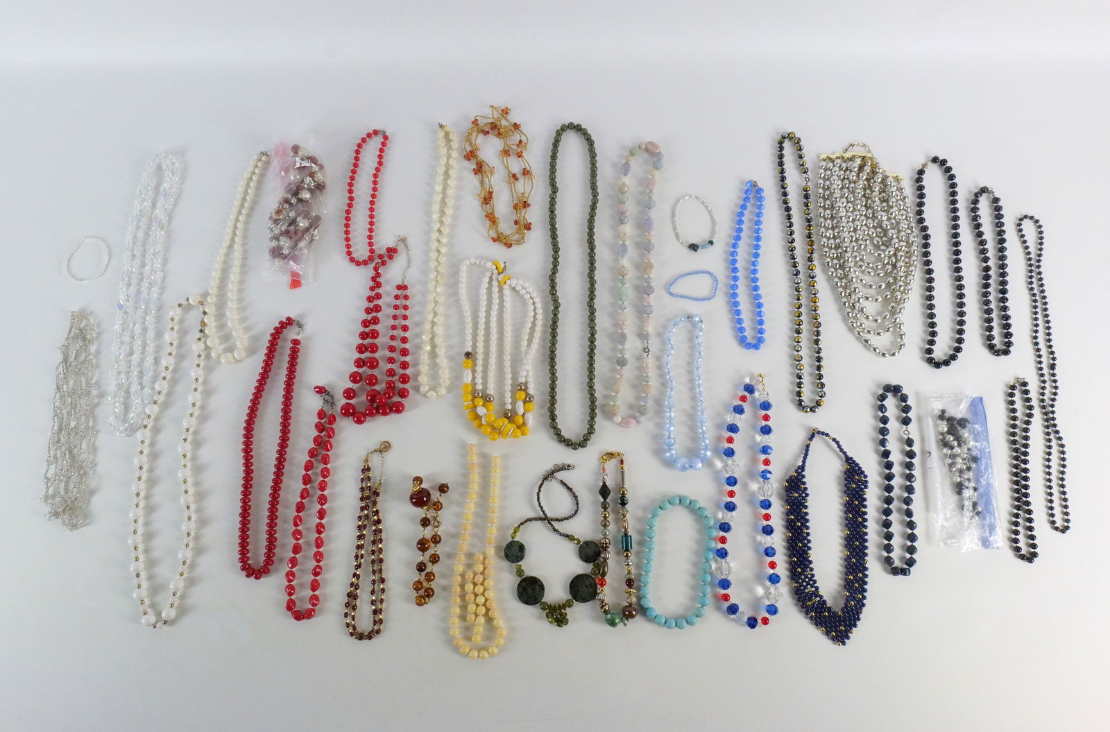 Group of Plastic Bead Costume Jewelry: Group of Plastic Bead Costume Jewelry. The lot includes 28 mostly vintage plastic bead necklaces ranging in length from 16'' to 100'' long and features necklaces by Trifari and The Limited. Also inclu