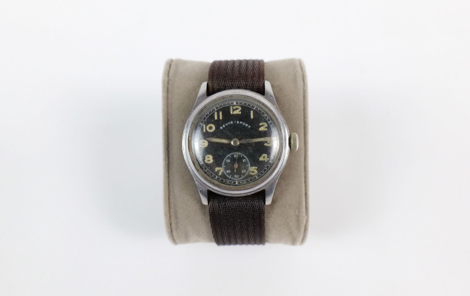 Rare WW2 Revue-Sport Military Watch: Rare WW2 Revue-Sport Military Watch. The lot includes a rare WW2 era, Swiss made Revue-Sport DH mechanical military cal.59 wrist watch. It features a 1.54'' x 1.38'' silver tone case, a domed plastic