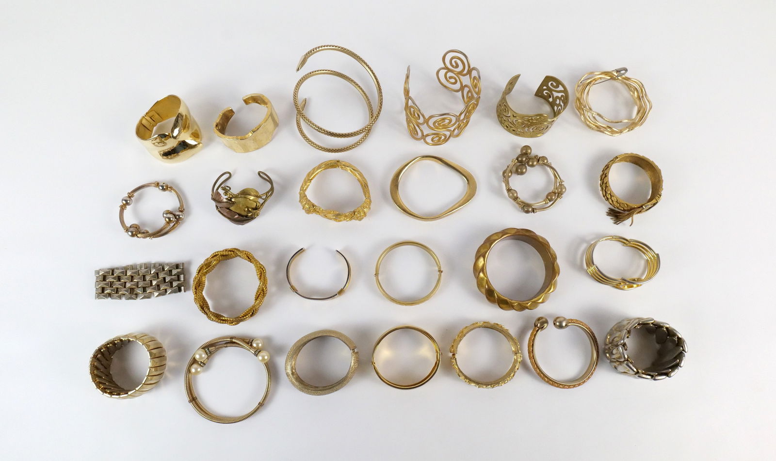 27 Modern and Vintage Cuff Bracelets and More : 27 Modern and Vintage Cuff Bracelets and More. The lot includes a large variety of 27 modern and vintage cuff and wrap style bracelets in a mix of styles. Also included is a lattice work gold tone coi