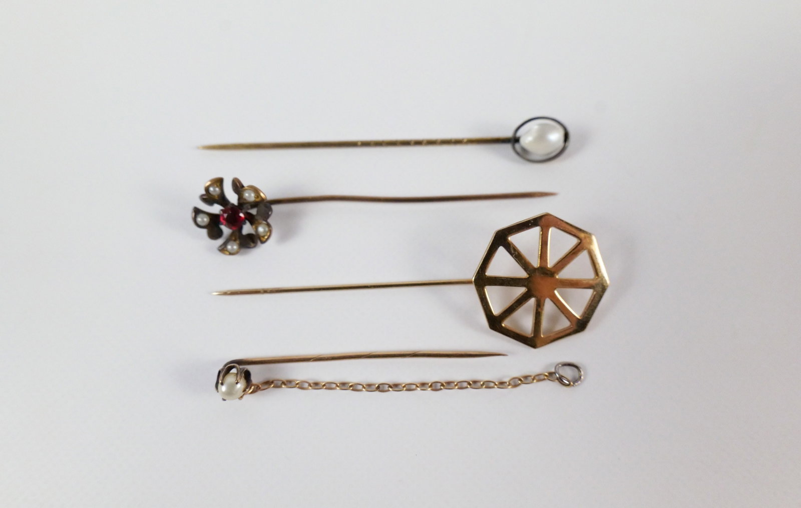 4 Gold Filled Antique and Vintage Stick Pins: 4 Gold Filled Antique and Vintage Stick Pins. The lot includes a mix of 4 vintage and antique gold filled stick and jabot pins ranging in size from 1 3/4'' to 2.5'' long. They mostly feature pearl acc