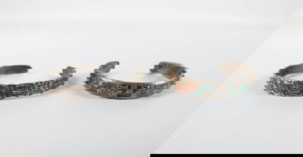 Pair of Vintage Sterling Cuff Bracelets: Pair of Vintage Sterling Cuff Bracelets. The lot includes a pair of vintage sterling cuff bracelets. Featuring a .36'' wide Native American sterling cuff bracelet with coral and turquoise chips inlaid
