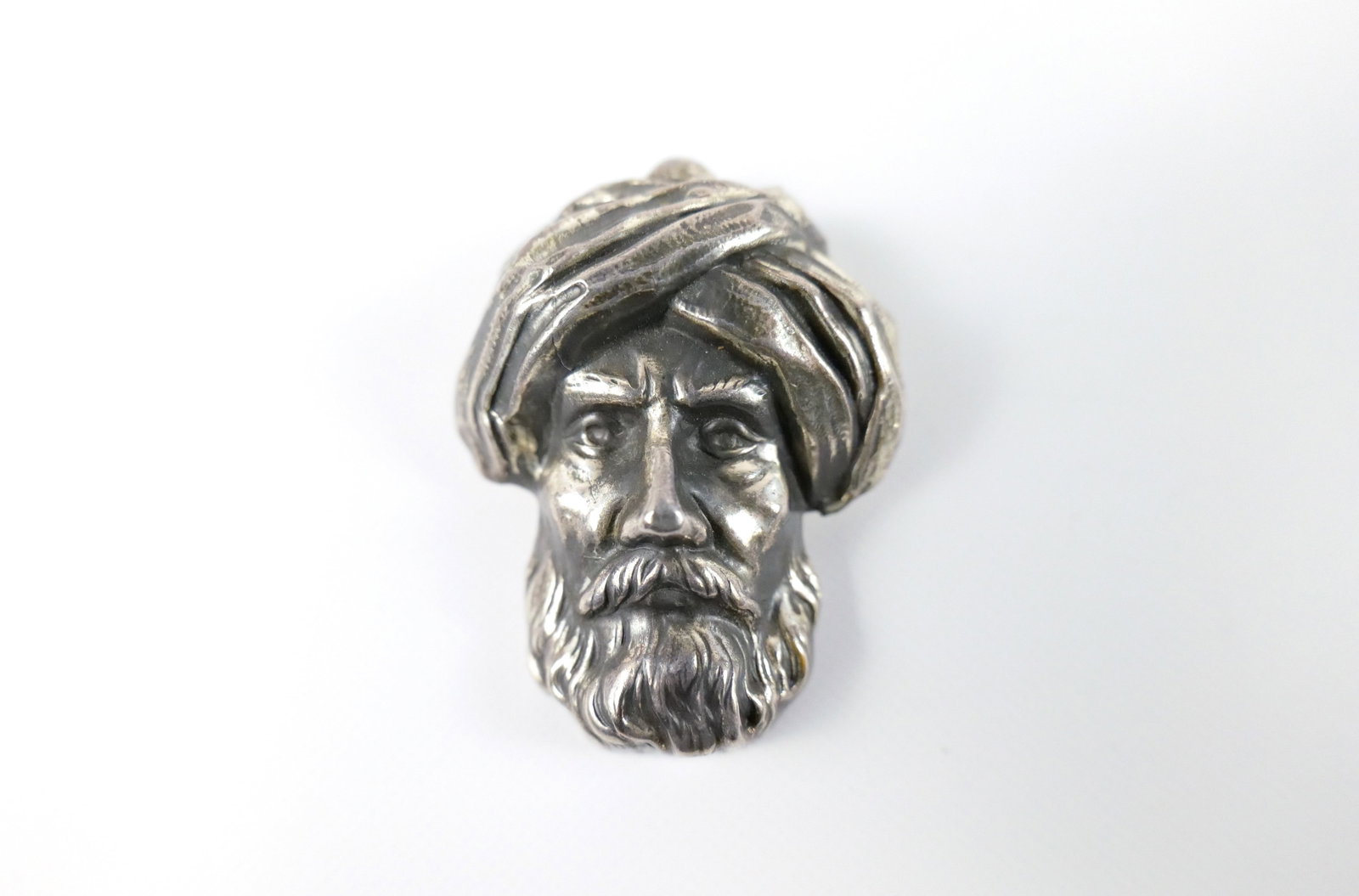 Vintage Sterling Arabian Man Brooch: Vintage Sterling Arabian Man Brooch. The lot includes a vintage 1940s, 1.97'' x 1.48'' vintage sterling brooch by Joseff Hollywood in the form of an Arabian man wearing a turban with a hinged bar clos