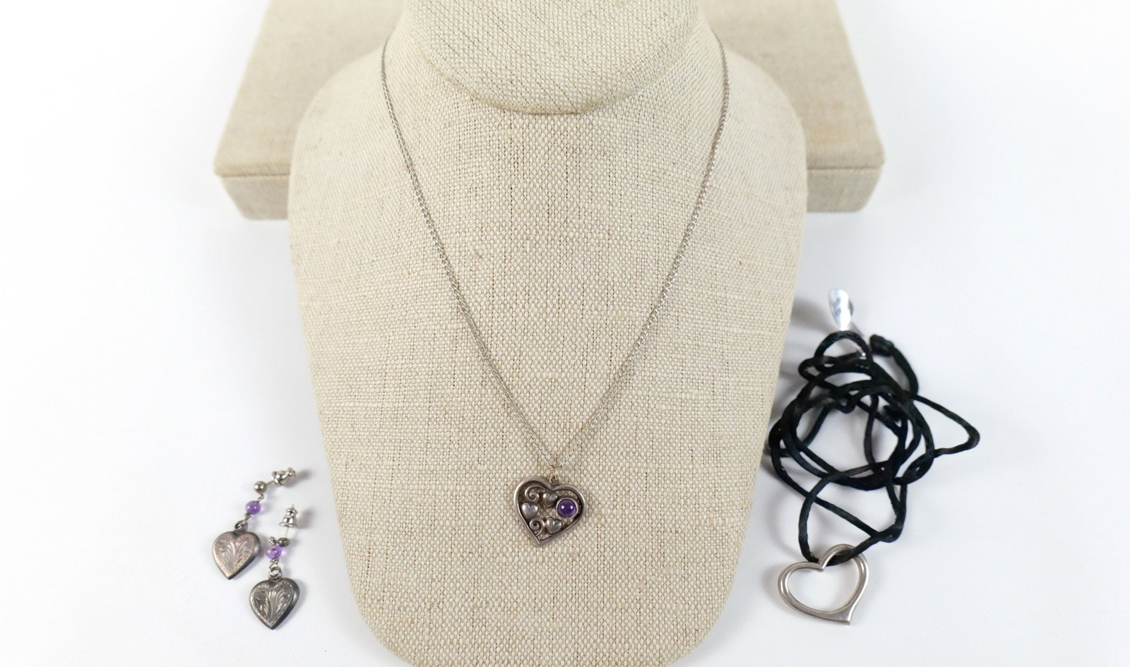 Group of Sterling Heart Jewelry: Group of Sterling Heart Jewelry. The lot includes a mix of sterling silver heart jewelry. Featuring a vintage 24'' long fine Cuban link chain by Speidel with a .76'' x .75'' heart pendant filled with 