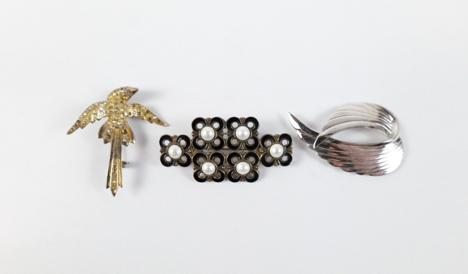 Group of 3 Vintage Sterling Brooches: Group of 3 Vintage Sterling Brooches. The lot includes a mix of three vintage sterling brooches. Featuring a 1 3/4'' x 1'' vintage gold tone sterling brooch from Norway comprised of stacked clover-lik