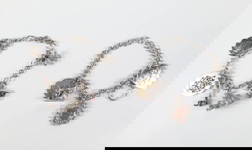 Pair of Vintage Sterling Charm Bracelets: Pair of Vintage Sterling Charm Bracelets. The lot includes a pair of vintage 1960s sterling charm bracelets. Featuring a 7'' long sterling figaro link bracelet with a spring ring clasp and 6 silver to