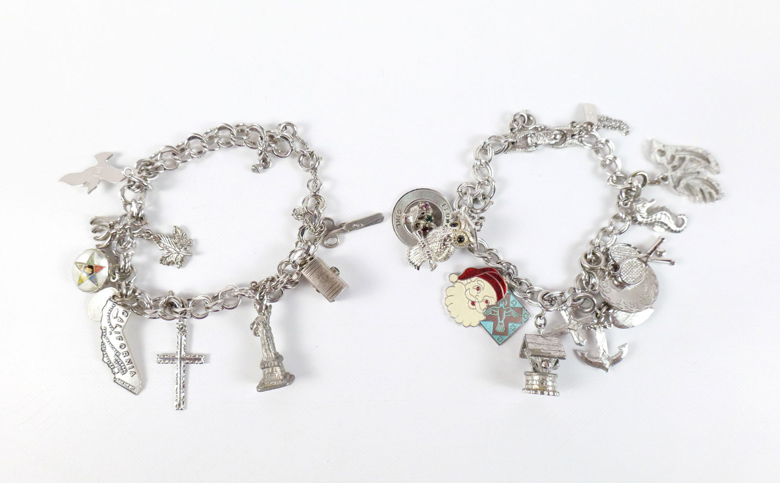 Pair of Vintage Charm Bracelets: Pair of Vintage Charm Bracelets. The lot includes a pair of vintage 1960s charm bracelets. Featuring an 8'' long sterling double round link bracelet with a a spring ring clasp and a safety chain, as w