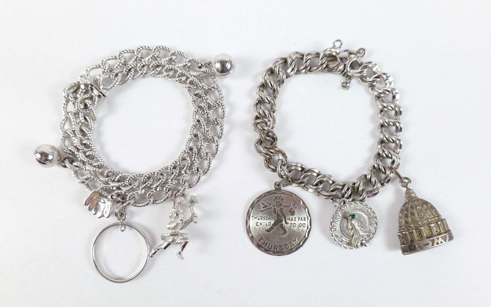 Pair of Vintage Sterling Charm Bracelets: Pair of Vintage Sterling Charm Bracelets. The lot includes a pair of vintage 1960s sterling charm bracelets. Featuring a 7.54'' long textured oval double chain link bracelet with a tongue clasp and fo