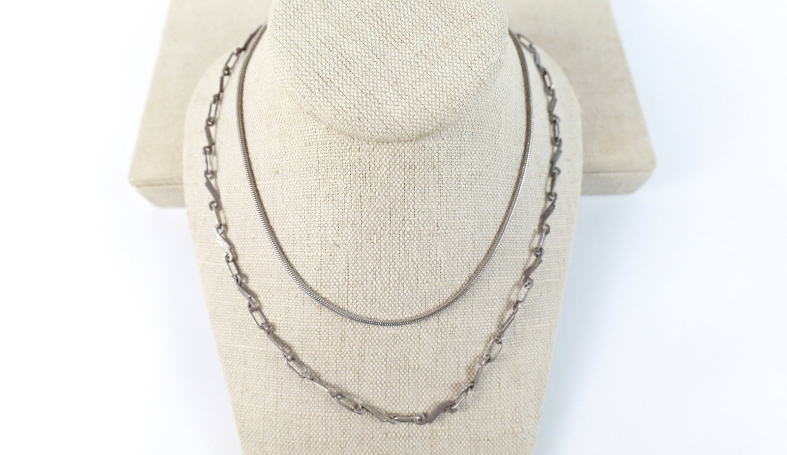 Pair of Sterling Chain Necklaces : Pair of Sterling Chain Necklaces. The lot includes a pair of sterling chain necklaces. Featuring a 14'' long sterling fluid chain necklace with a spring ring closure, marked sterling. As well as a 19'