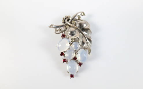 Vintage 1940s Sterling Trifari Grape Fur Clip: Vintage 1940s Sterling Trifari Grape Fur Clip. The lot includes a vintage 1940s 2.16'' x 1.28'' Trifari fur clip in the form of a bunch of grapes hanging from the vine with oval glass moonstone caboch