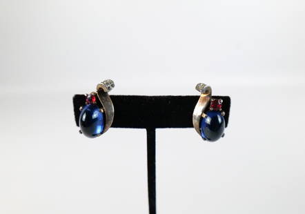 Pair of Vintage 1940s Sterling Trifari Earrings: Pair of Vintage 1940s Sterling Trifari Earrings. The lot includes a vintage 1940s pair of .92'' x .53'' gold vermeil sterling clip on earrings by Trifari with oval blue glass cabochons and red glass r