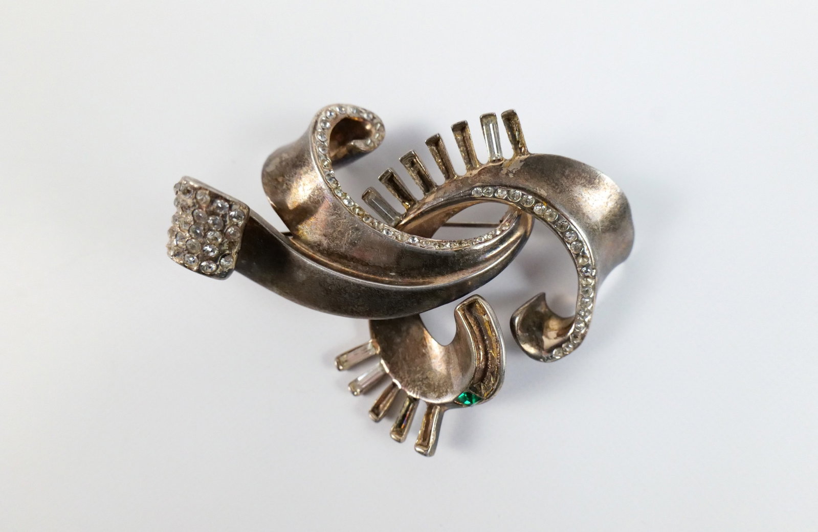 Vintage 1940s Sterling Brooch by Glamour : Vintage 1940s Sterling Brooch by Glamour. The lot includes a vintage 1940s 2.22'' x 2.85'' sterling scroll work brooch by Glamour with green and clear rhinestone accents and a hinged bar closure with 