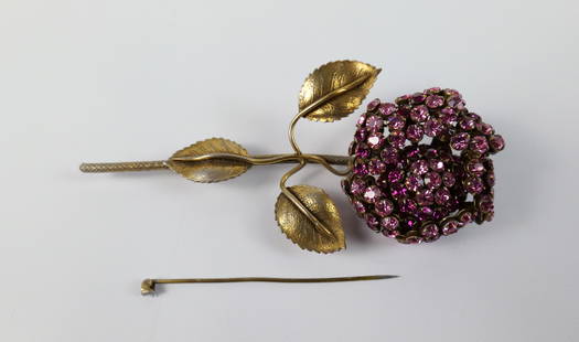 Midcentury Large Rose Brooch by Sandor: Midcentury Large Rose Brooch by Sandor. The lot includes a vintage midcentury 4.60'' x 2.12'' gold tone rose brooch by Sandor with a pink crystal glass rhinestoned flower. The hinged bar backing is