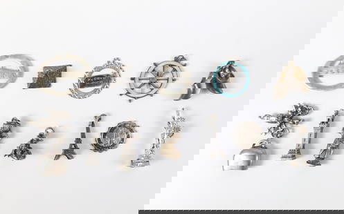 Group of 12 Vintage Sterling Souvenir Charms: Group of 11 Vintage Sterling Souvenir Charms. The lot includes a mix of 11 vintage souvenir themed sterling charms. Including a pyramid, a ships helm with guilloche enamel, the Eiffel tower, a man pan