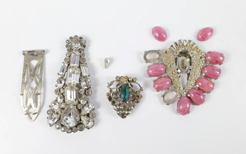 Trio of 1940s Salvaged Dress Clips: Trio of 1940s Salvaged Dress Clips. The lot includes a mix of 3 salvaged vintage 1940s rhinestone dress clips. Featuring a large 3.26'' x 1.61'' silver tone Eisenberg dress clip with a fully rhineston
