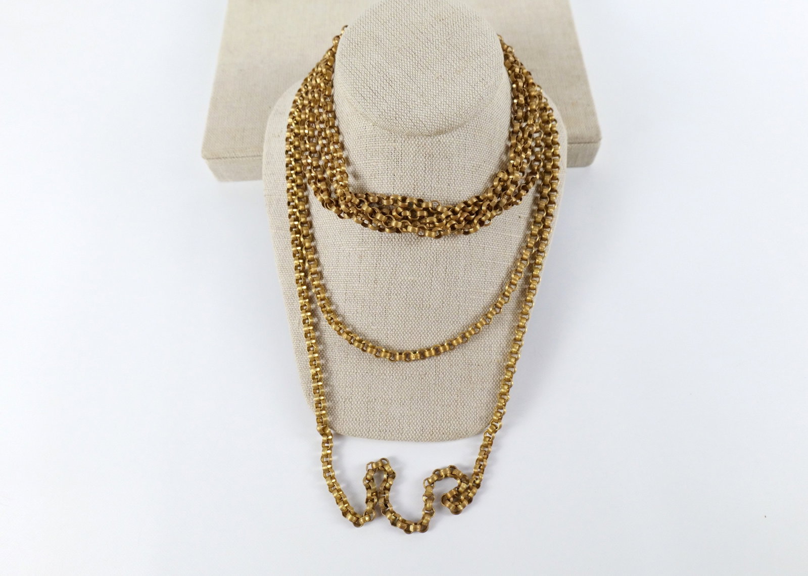 Pair of Art Deco Brass Rolo Chain Necklaces: Pair of Art Deco Brass Rolo Chain Necklaces. The lot includes a pair of vintage art deco rolo chain necklaces. Featuring a 60'' long ribbed rolo link chain. As well as a matching 29'' long double stra