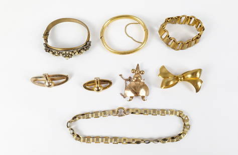 Group of Brass Art Deco Bracelets and More: Group of Brass Art Deco Bracelets and More. The lot includes a mix of vintage art deco brass jewelry. Featuring a hinged brass bangle with faux pearl and faux garnet accents. A 7'' long brass bracelet