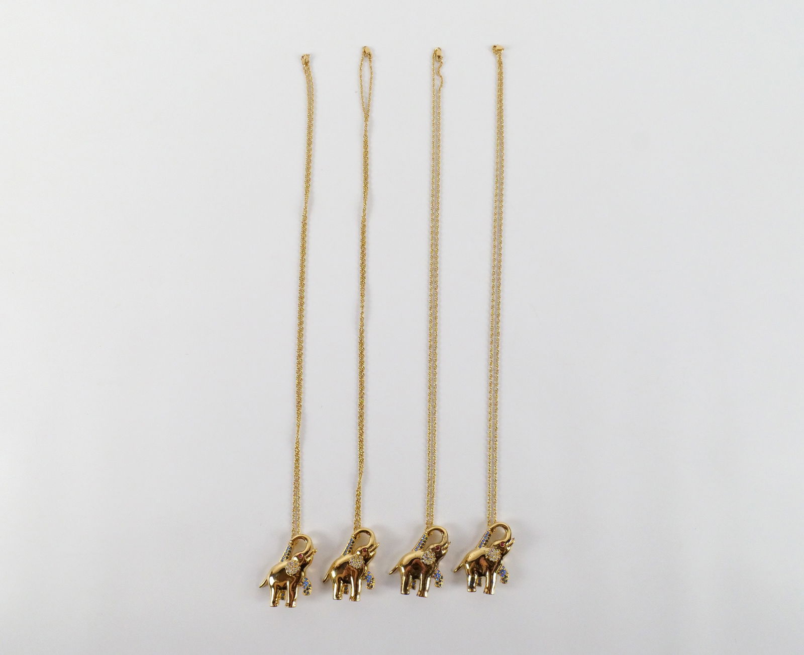 4 Gorham Sterling Elephant Pendants/Brooches : 4 Gorham Sterling Elephant Pendants/Brooches. The lot includes four gold tone sterling elephant pendants/brooches by Gorham with white and blue rhinestone accents and a 2mm round genuine ruby eye. The