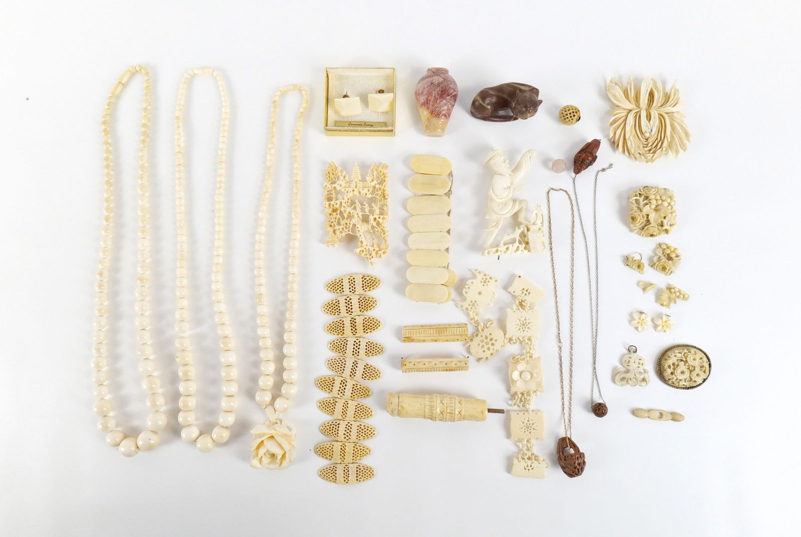 Large Group of Carved Bone and Stone Items: Large Group of Carved Bone and Stone Items. The lot includes a wide variety of carved bone and stone jewelry and items. Featuring a mix of vintage and antique carved Indian and Asian items. All invoic