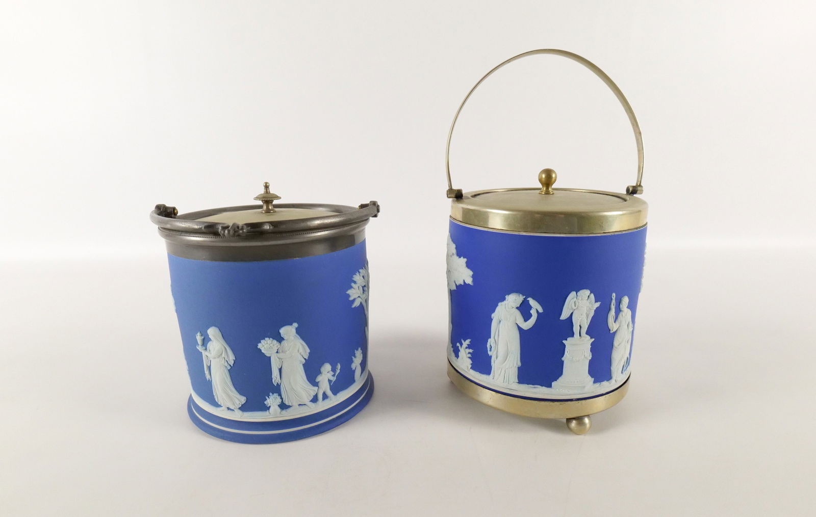 Lot of 2 Wedgwood Blue Jasper Covered Tobacco Jars: Lot of 2 Wedgwood Blue Jasper Covered Tobacco Jars. One has silverplated rim and base. Largest measures 6" tall x 5.5" diameter. All invoices must be paid within 24 hours of the sale. We offer multipl