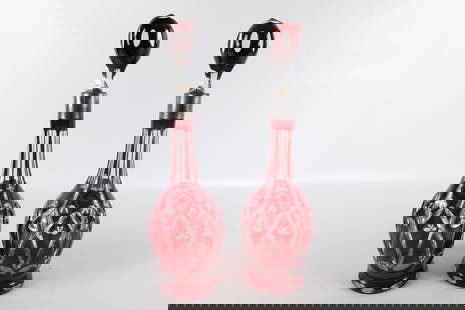 Pair of Ruby Cut to Clear Decanters: Pair of Ruby Cut to Clear Decanters. One has minor fleabite chips at the base. Measures 16" tall. All invoices must be paid within 24 hours of the sale. We offer multiple shipping options please read