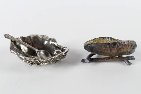 Lot of 2 Vintage Salt Cellars: Lot of 2 Vintage Salt Cellars. Including Oyster Bowl Shaped with Spoon, and Metal Shaped Brazil Nut on Twig Base Salt Cellar. Tallest measures 1". All invoices must be paid within 24 hours of the