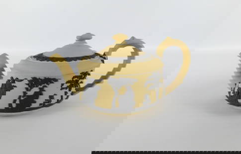 Wedgwood Buff Yellow Teapot with Black Relief: Wedgwood Buff Yellow Teapot with Black Relief Motif. Some scuffing on teapot. Measures 4" tall x 8.5" long. All invoices must be paid within 24 hours of the sale. We offer multiple shipping options, p