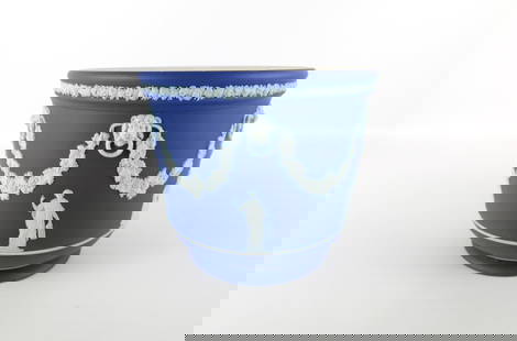 Wedgwood Cobalt Blue Jasperware Jardiniere: Wedgwood Cobalt Blue Jasperware Jardiniere. Depicting Neoclassical Muses in white bas relief with lions heads and garland draped around. Some bubbles under the glaze at the bottom rim. Measures 7.25"