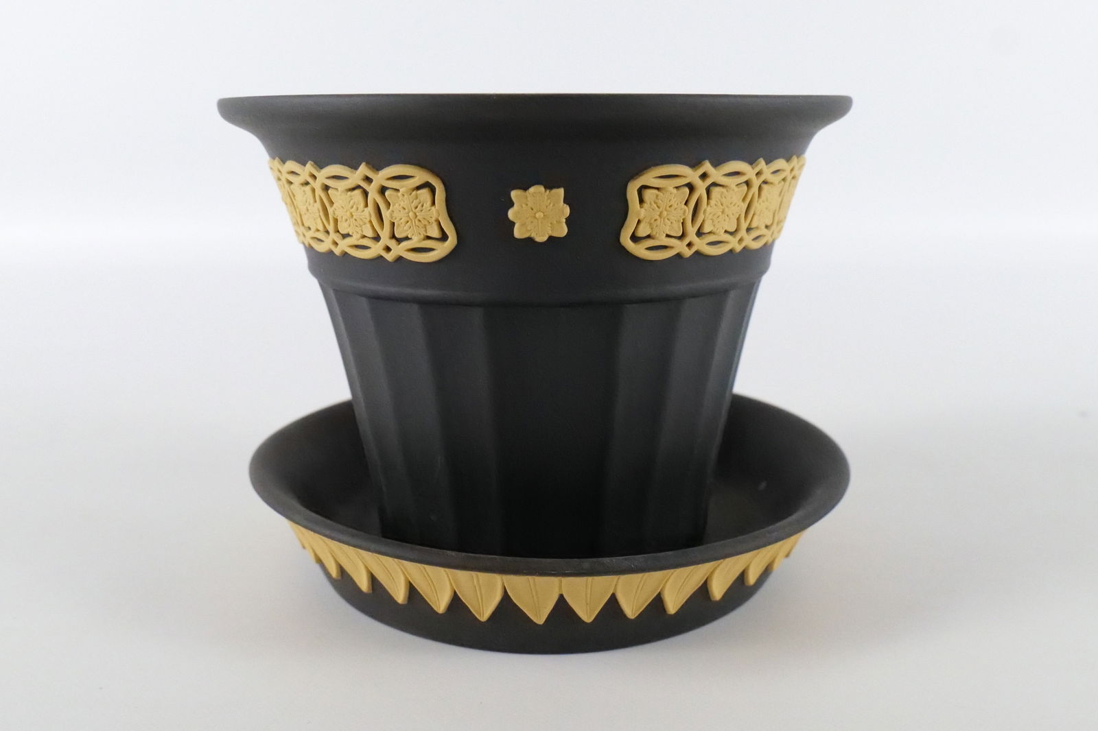 Wedgwood Library Collection Opus Planter and Underplate: Wedgwood Library Collection Black Jasperware and Cane Yellow Opus Planter and Underplate. Planter measures 4" tall. Underplate measures 5.5" long. All invoices must be paid within 24 hours of the sale