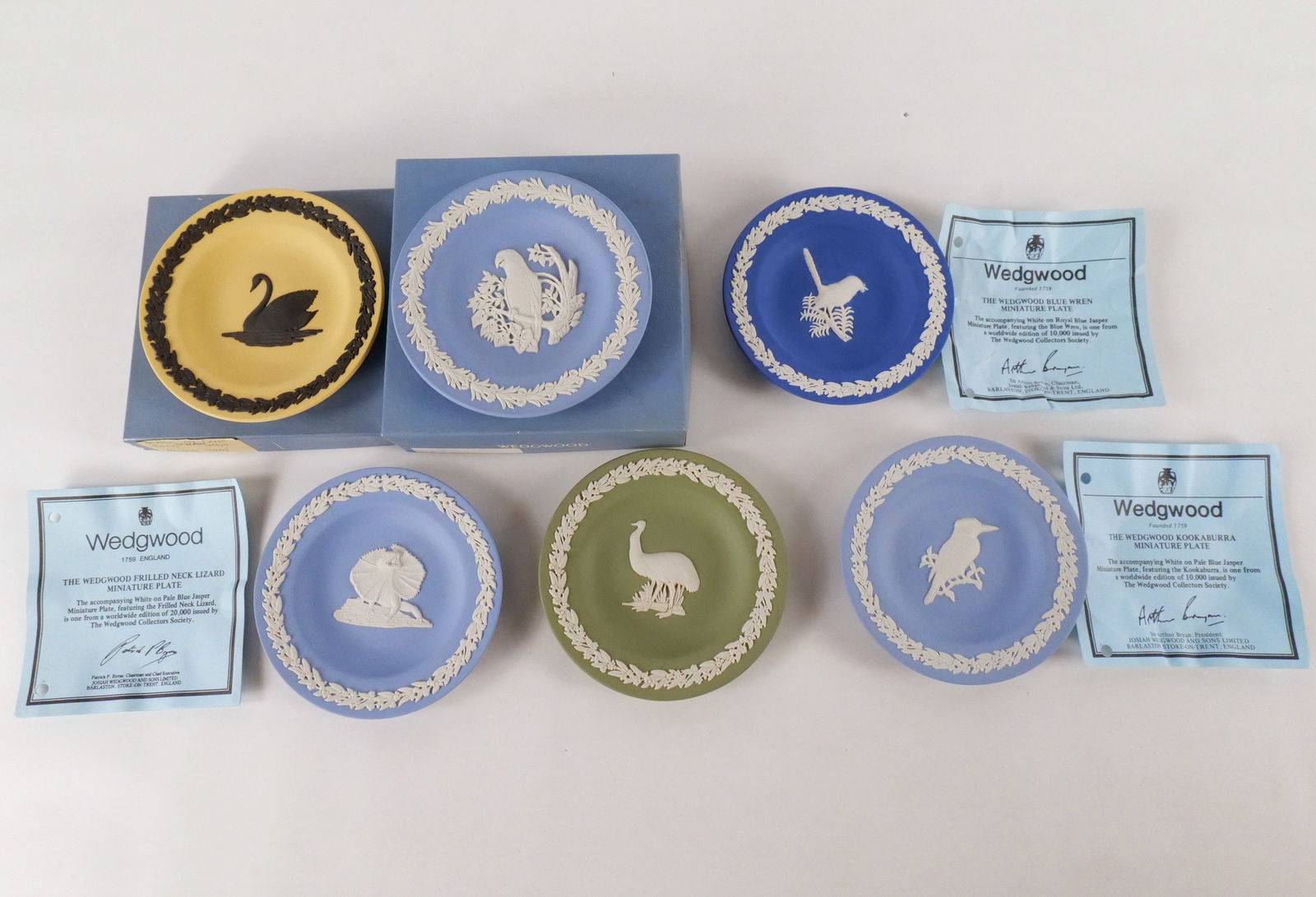 Lot of 6 Wedgwood Jasperware Small Round Animal Plates: Lot of 6 Wedgwood Jasperware Small Round Animal Plates. Including Black on Cane Jasperware Swan, White on Sage Green Emu, White on Royal Blue Wren, and Pale Blue, Kookaburra, Parrot and Neck Lizard. T