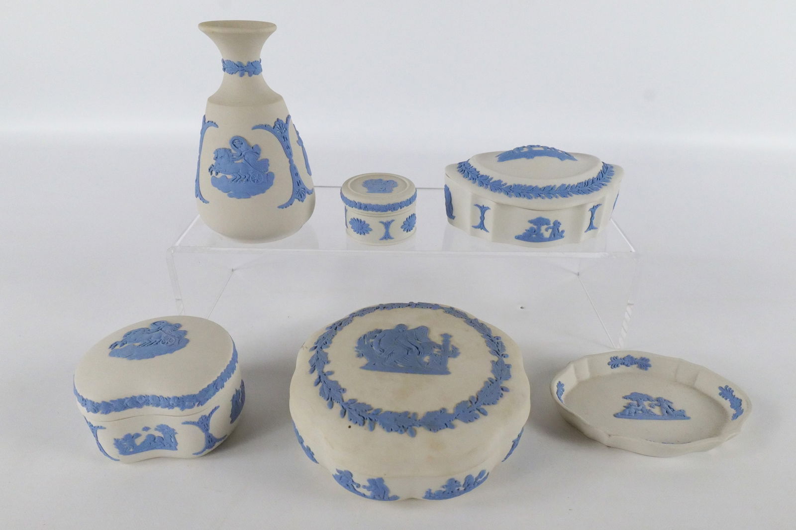 Lot of 6 Wedgwood Reverse Blue on White Jasperware Pieces: Lot of 6 Wedgwood Reverse Blue on White Jasperware Pieces. Including Scalloped Dresser Box - Some Scuffing, Oval Dresser Box, Kidney Shaped Trinket Box, Round Trinket Box, Bud Vase and Oval Ring Dish.