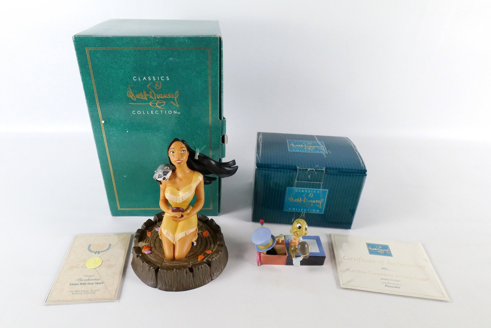 Lot of 2 WDCC Figurines: Lot of 2 WDCC Figurines. Including "Listen to Your Heart" - Pocahontas and "Let Your Conscience Be Your Guide" - Jiminy Cricket. Largest measures 7.5" tall. Both come with boxes and COA's. All invoice