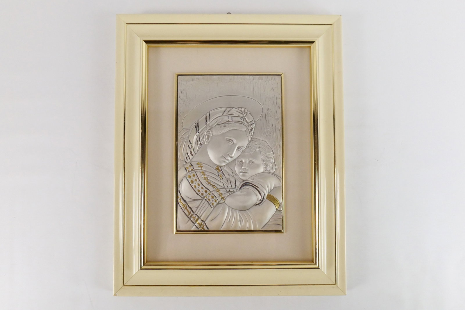 Framed Sterling Silver Madonna and Child Art: Framed Sterling Silver Madonna and Child Art. Artist Signed lower right. Frame has some damage to the corners. Measures 21.5" tall x 17.5" wide. All invoices must be paid within 24 hours of the sale. 