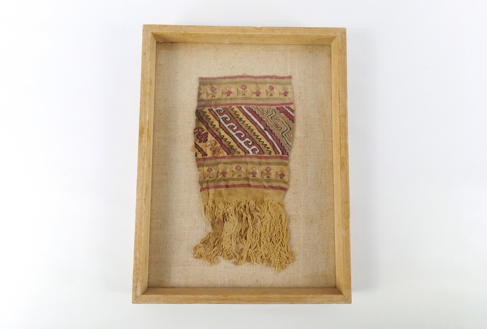 Pre-Columbian Framed Cloth: Pre-Columbian Framed Cloth. 12th-15th Century Peruvian Chimu People. Frame has chip on top and a couple little chips on the bottom. Measures 18" tall x 13.5" wide. All invoices must be paid within 24