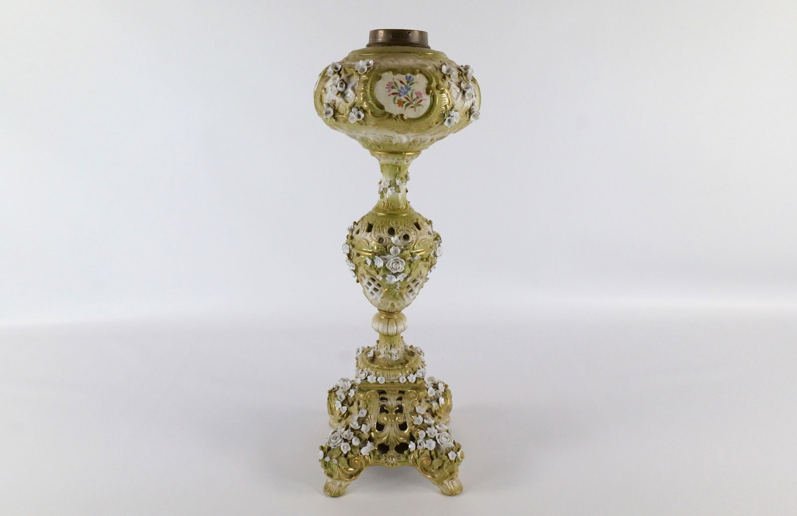 19th Century Porcelain Piano Oil Lamp: 19th Century Porcelain Piano Oil Lamp. Marked Germany. Has cross sword marks. Flowers have chipping throughout. Slight lean. Measures 20" tall x 7" diameter. All invoices must be paid within 24 hours