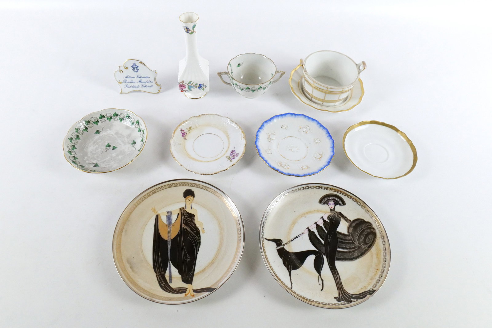 Lot of Porcelain Pieces: Lot of Porcelain Pieces. Including Meissen, KPM, Aynsley, House of Erté. Including Saucers, Cups, Vases, and More. Cup and Saucer from Hungary has a hairline crack on the cup. Pieces in this lot may