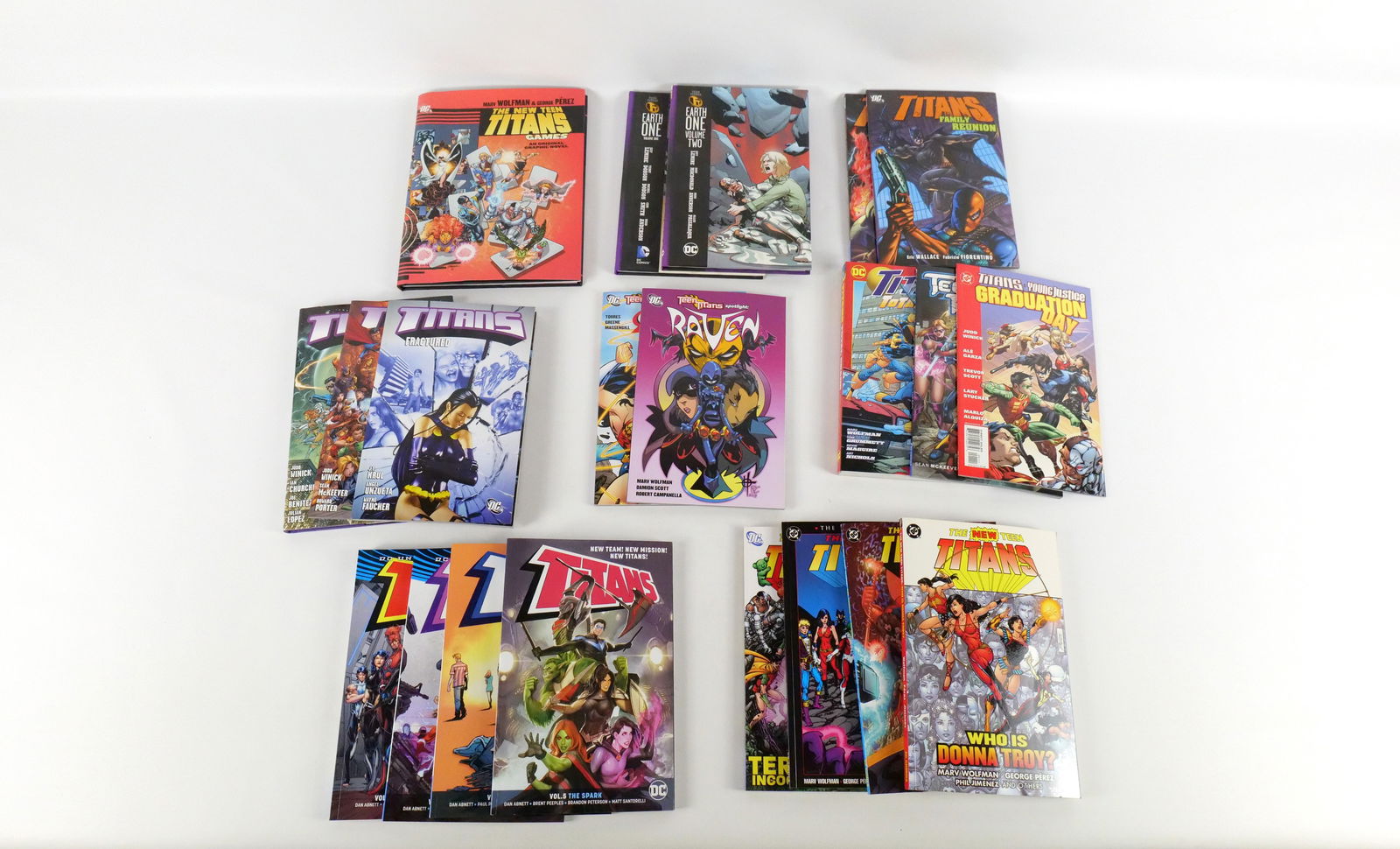 Lot of Teen Titans Trade Paperbacks and Hardcover Books: Lot of Teen Titans Trade Paperbacks and Hardcover Books. Including The New Teen Titans: Games Hardcover, Teen Titans Earth One Vol. 1 & 2 - Hardcovers, Titans: Old Friends Hardcover. The rest of the l