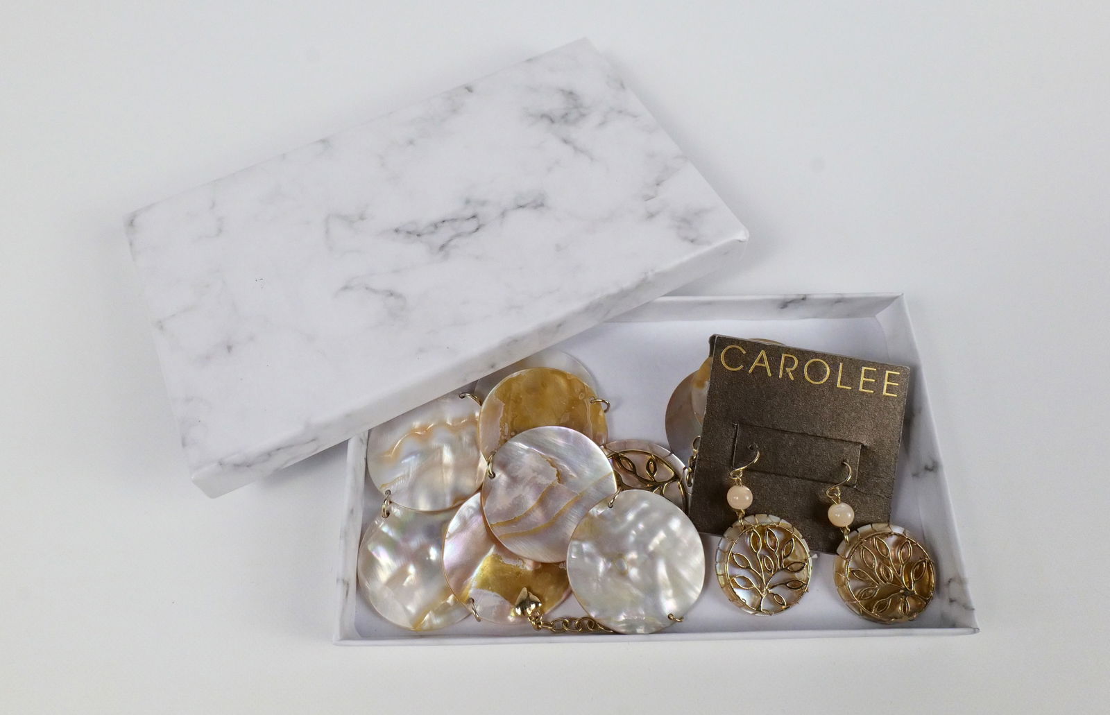 Abalone Disc Necklace and Earrings Set by Carolee: Abalone Disc Necklace and Earrings Set by Carolee. The lot includes a matching necklace and earrings set by Carolee. Featuring a an adjustable 20.5'' long necklace comprised of 1.35'' abalone discs wi