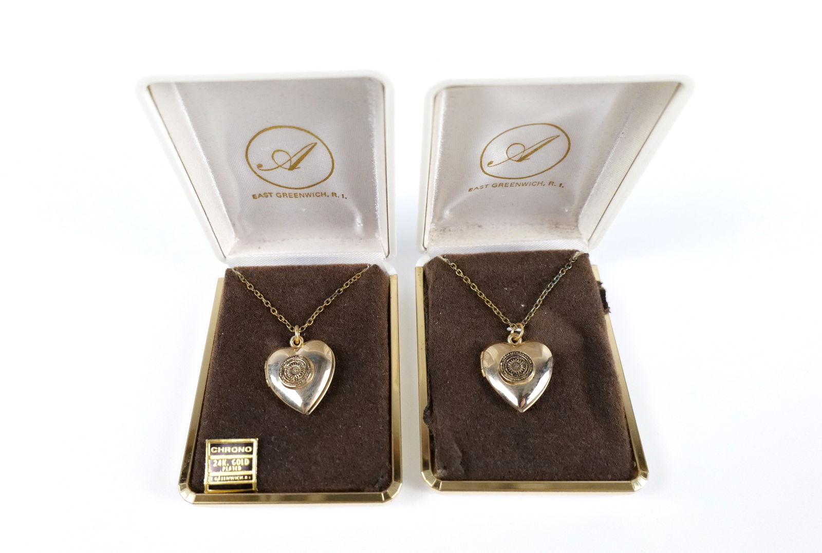 Vintage Pair of 24K Gold Plated Rutgers Lockets: Vintage Pair of 24K Gold Plated Rutgers Lockets. The lot includes a pair of vintage 1970s, 24K yellow gold plated necklaces by Chrono with .92'' long by .77 wide locket pendants featuring the Rutgers