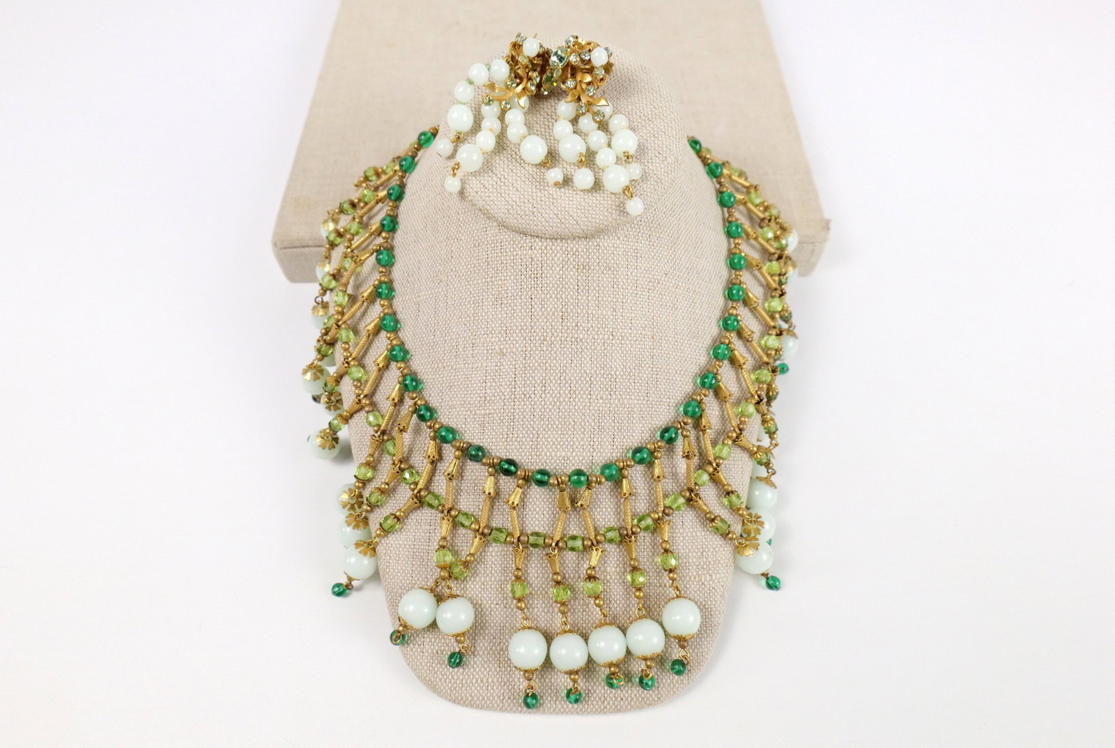 Mid Century Egyptian Revival Necklace and More: Mid Century Egyptian Revival Necklace and More. The lot includes an adjustable gold tone 1950s/60s Egyptian revival necklace featuring stamped brass beads and findings, as well as glass beads in light