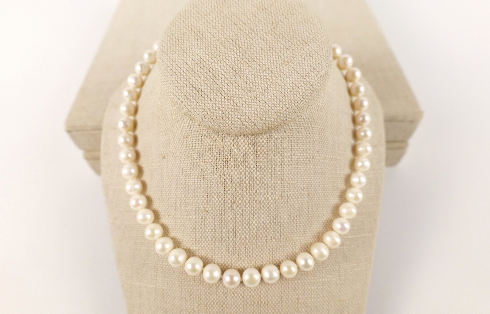 Hand Knotted Strand of Freshwater Pearls: Hand Knotted Strand of Freshwater Pearls. The lot includes a 16.5'' long strand of hand knotted 8mm-9mm white freshwater pearls with a 14K gold filled ball clasp. All invoices must be paid within 24 h