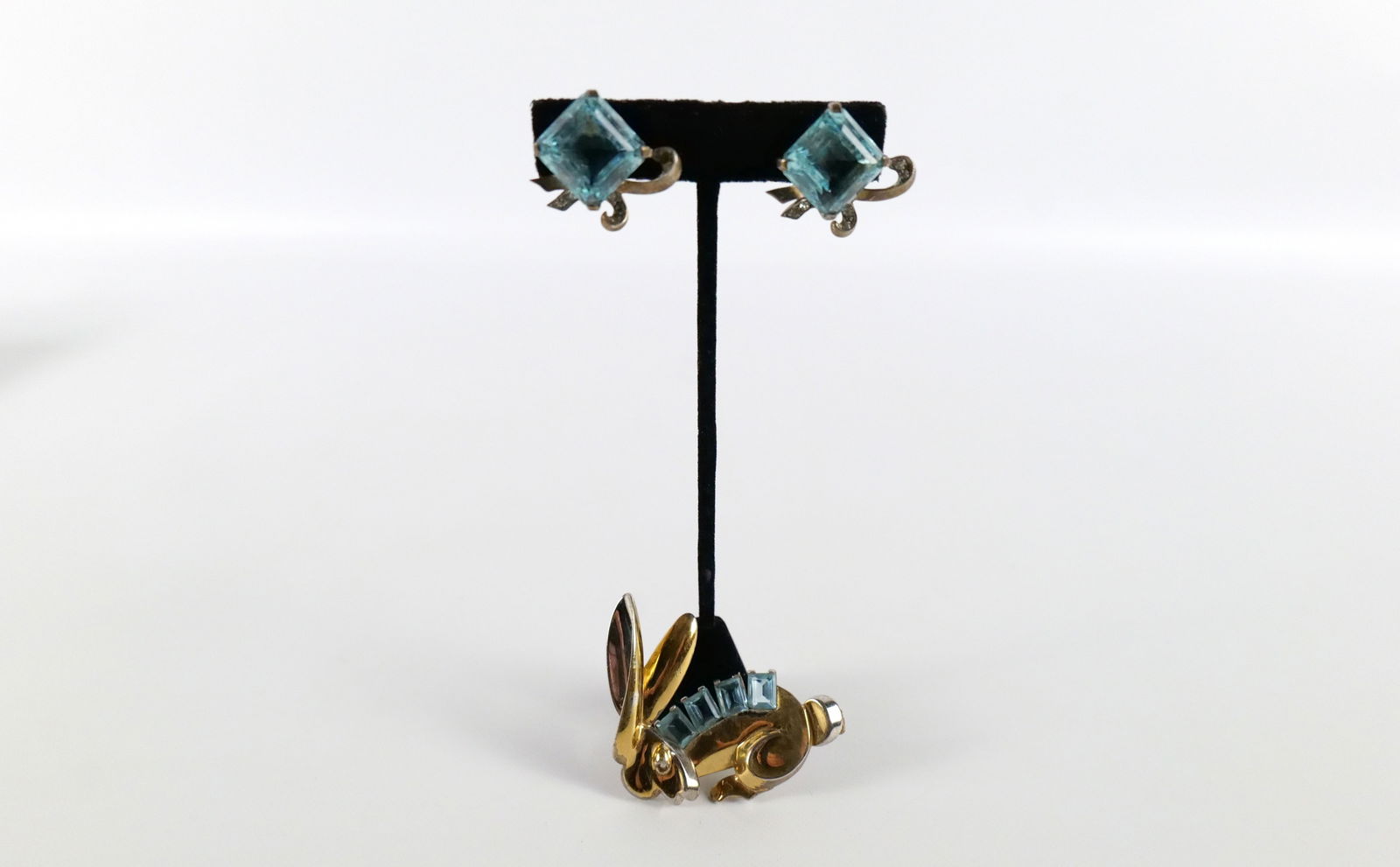 Vintage 1940s Sterling Earrings and Bunny Brooch: Vintage 1940s Sterling Earrings and Bunny Brooch. The lot includes a vintage 1940s 2.05'' x 1.88'' gold vermeil sterling bunny brooch possibly by Karu Fifth Avene set with 4 emerald cut aqua glass gem