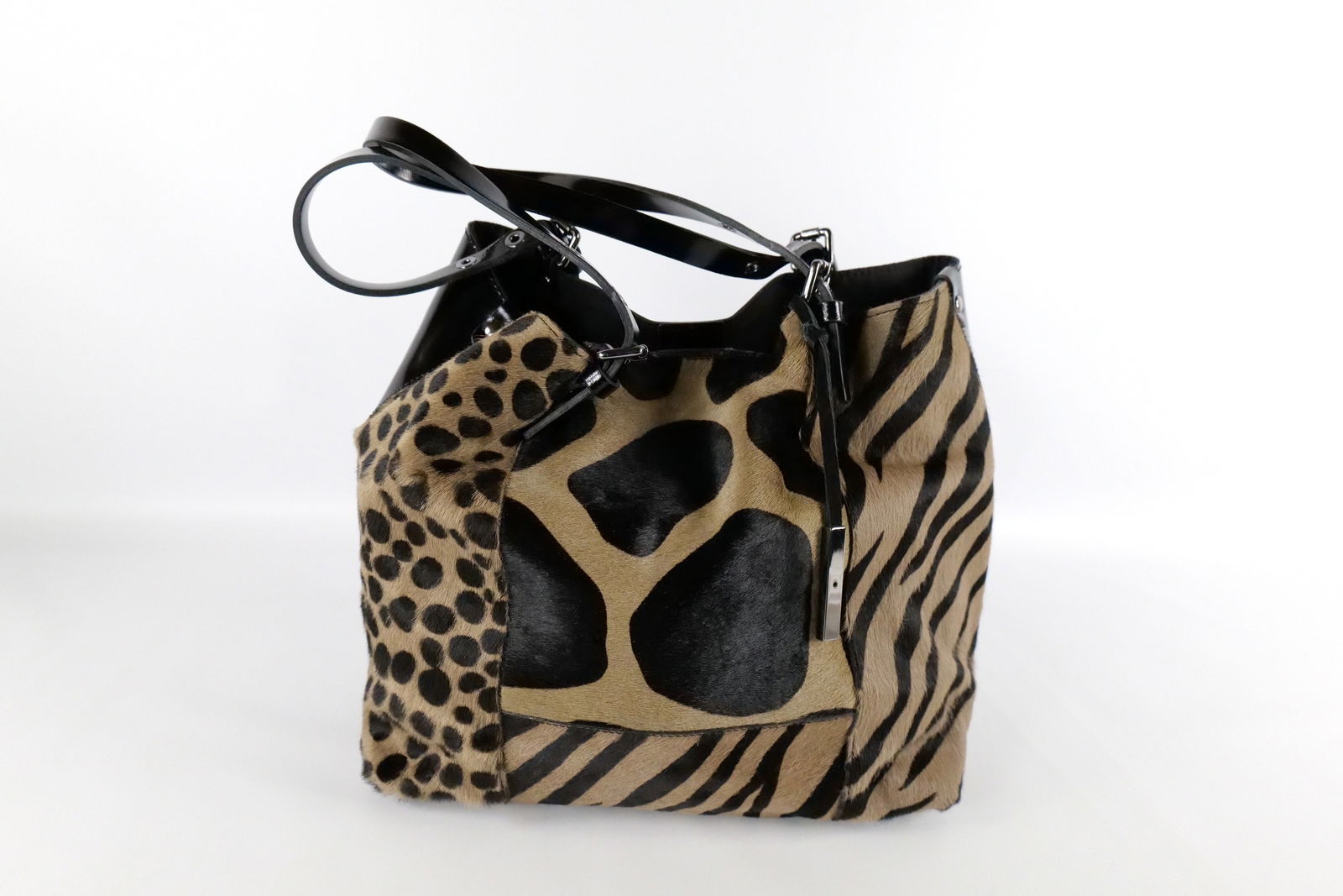 Innue Animal Print Hobo Bag: Innue Animal Print Hobo Bag. Black Patent Leather and Calf Hair. Comes with Dust Jacket. Very Good Condition. Measures 12" x 18". All invoices must be paid within 24 hours of the sale. We offer multip